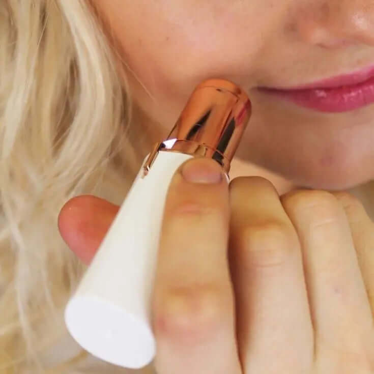 Gleame pain-free facial hair removal tool with rose gold and white design used on face