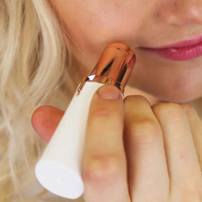 Gleame pain-free facial hair removal tool with rose gold and white design used on face